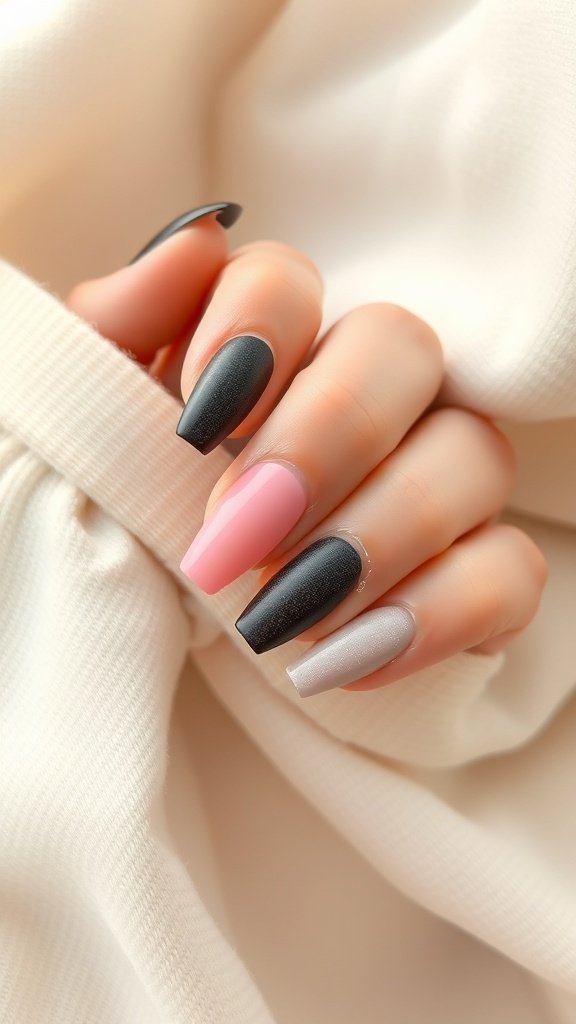 A close-up of short square acrylic nails featuring a textured matte and gloss combo with embellishments.
