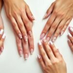 Collection of elegant short French tip acrylic nails designs featuring classic white tips and modern variations