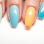 Duck nails acrylic in various colors showing the distinctive flared shape