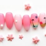 Various pink beach nail designs showcasing different styles from subtle pastels to bright corals with beach-themed accents