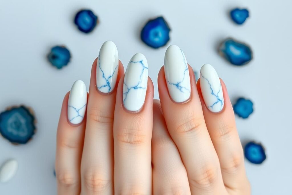 White marble effect nails with blue veins resembling coastal stones