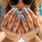 Woman with beautiful beach nails relaxing by the ocean