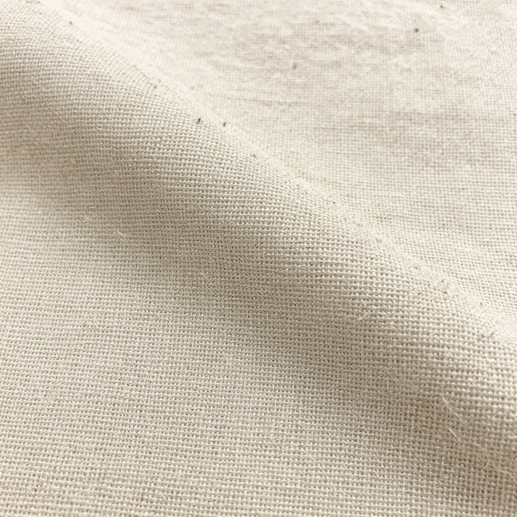 Close-up of beige linen pants fabric texture