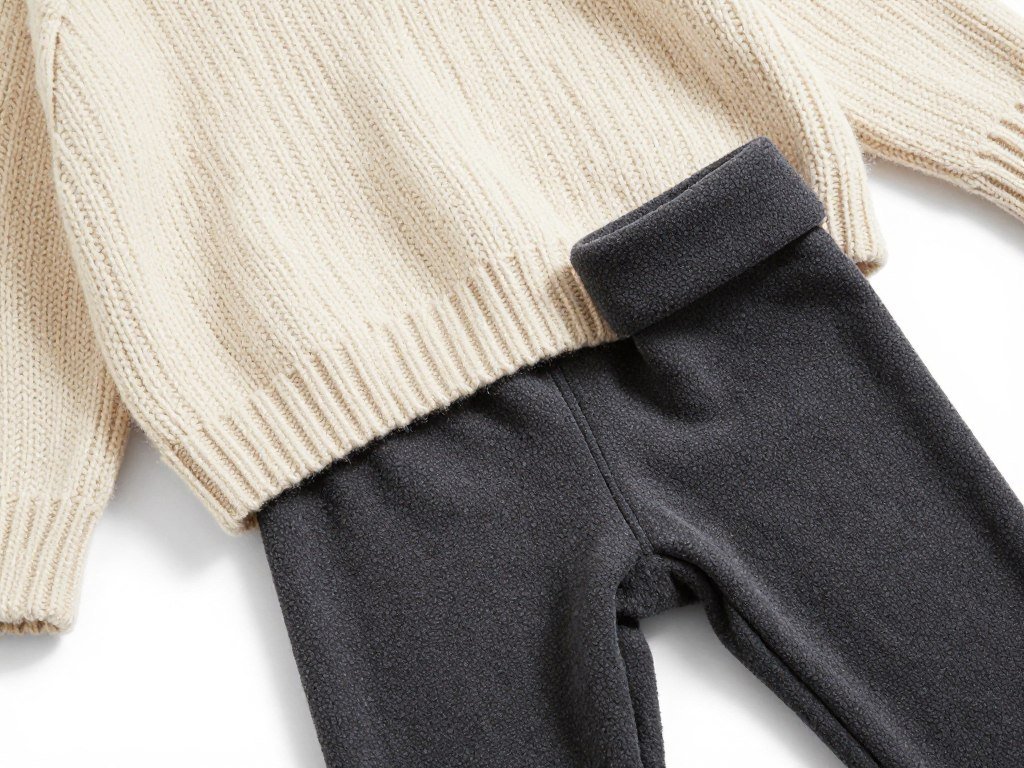 Close-up of fleece-lined leggings and oversized sweater texture for winter school outfits