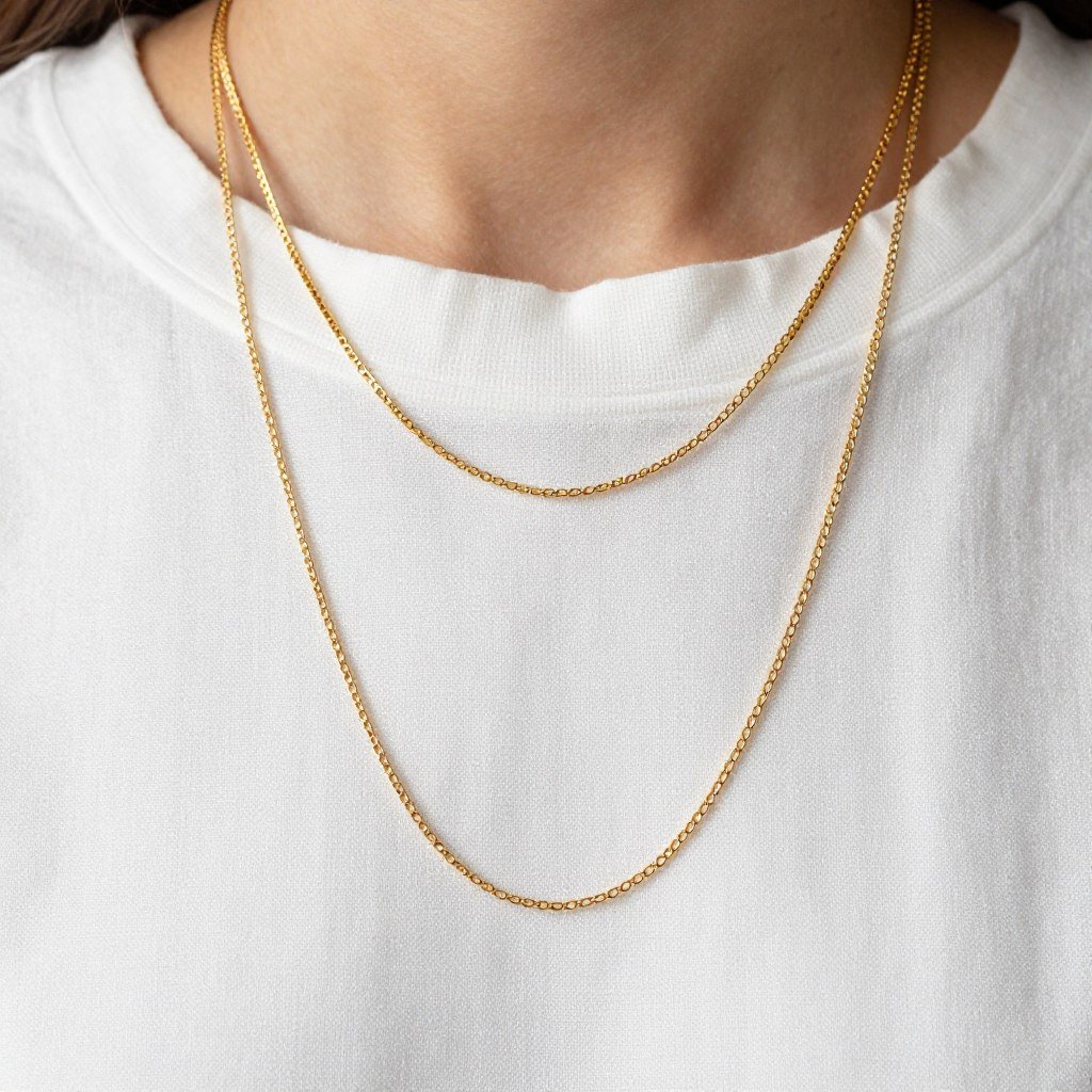 Close-up of layered necklaces and accessories to complement layered linen outfit