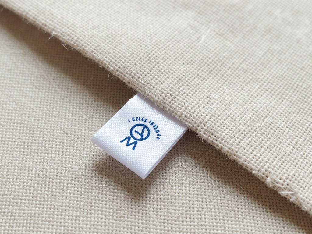 Close-up of linen fabric texture with care instructions visible