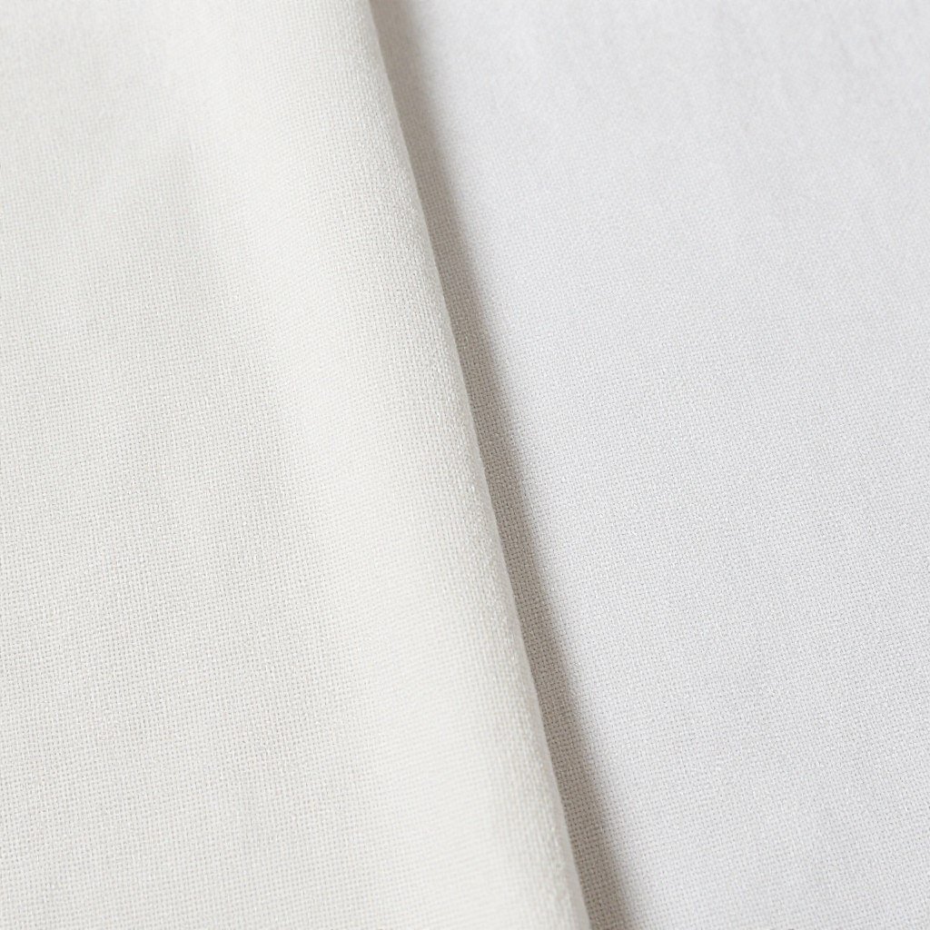 Close-up of textural details in monochromatic linen outfit showing different weaves