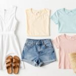 Collection of essential casual summer outfits for women including linen dresses, shorts, and lightweight tops laid out on a white background