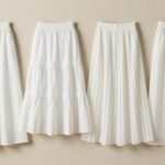 Various styles of white maxi skirts including A-line, tiered, pleated, and straight cuts displayed on a neutral background