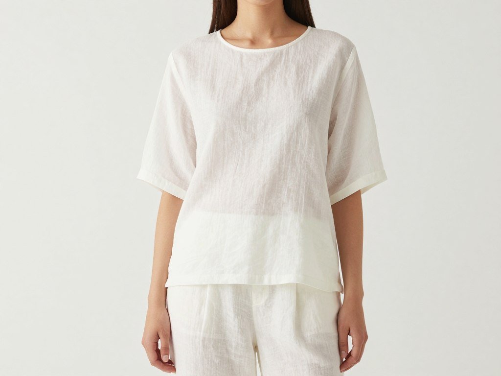 Woman in all-white linen outfit with matching pants and top