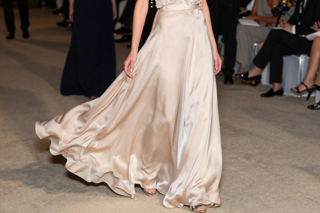 Woman in champagne silk maxi skirt with beaded top for formal event