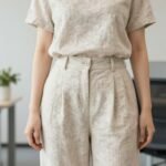 Woman wearing casual summer work outfit made of linen fabric in neutral tones