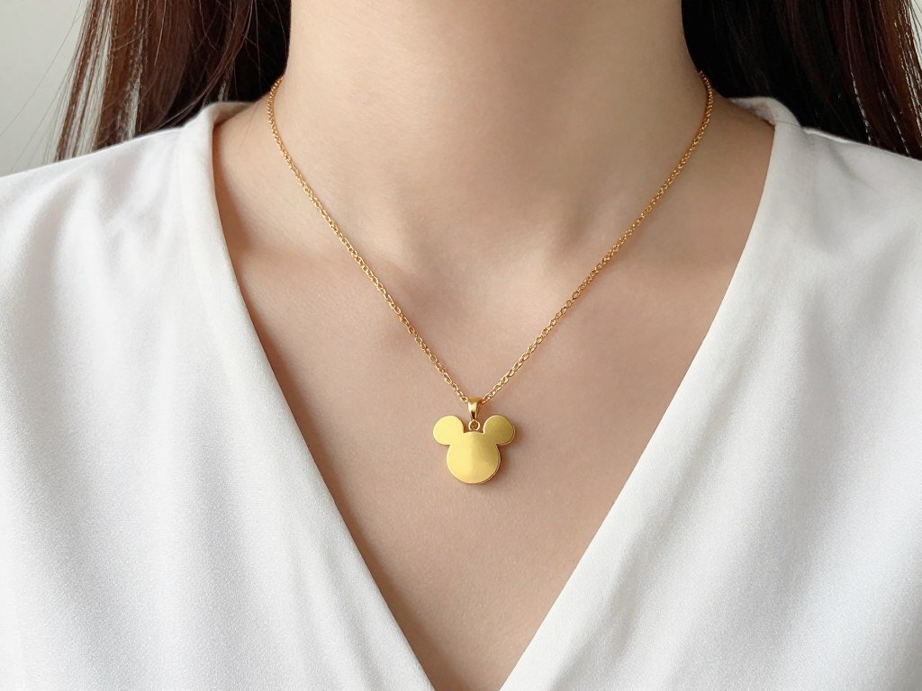 Woman wearing minimalist Mickey Mouse silhouette necklace with casual outfit