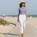 Woman wearing white linen pants with a striped top for summer