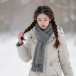 Woman with a winter hair braid walking in snow, showcasing how braids protect hair from harsh winter elements