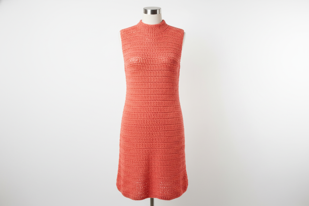 Coral colored simple tank crochet dress on mannequin