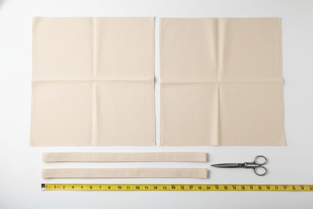 Flat lay of cut fabric pieces for a basic tote bag pattern with measurements