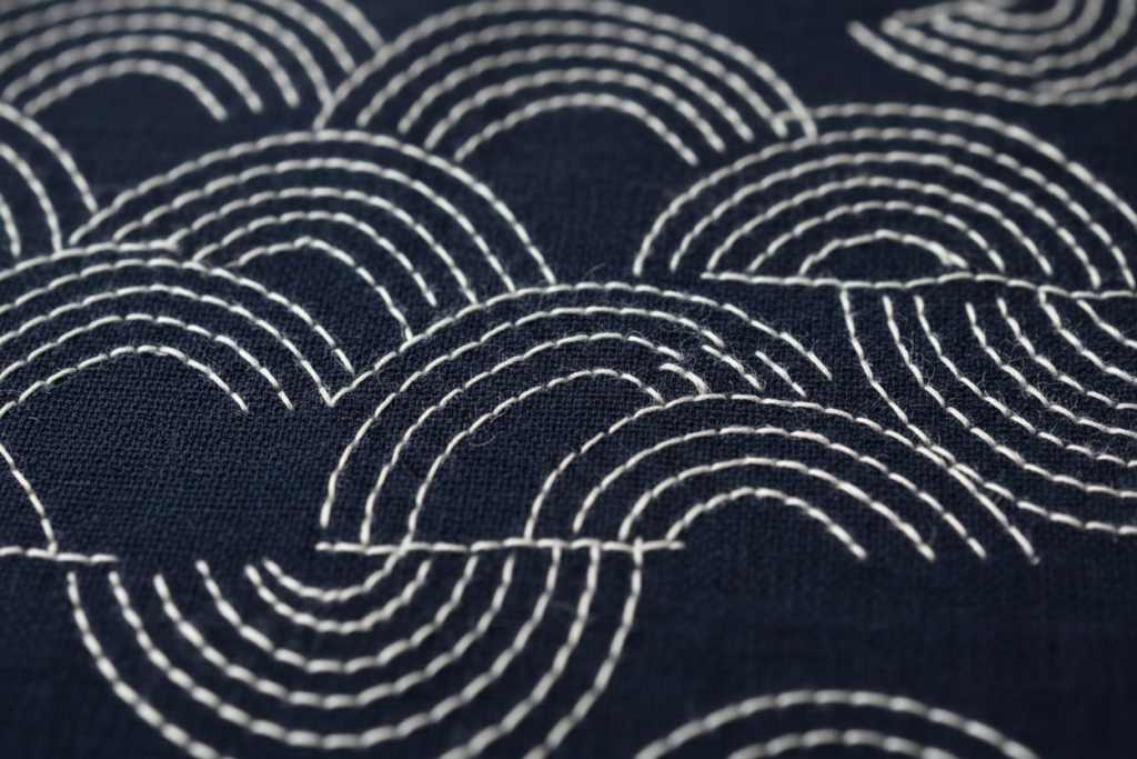 close-up of sashiko stitching pattern on dark fabric