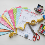 sewing projects for beginners clothing with fabric samples and simple dress patterns laid out on table