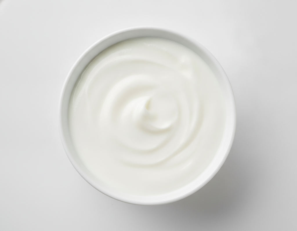 Plain yogurt in bowl with lactic acid for skin care home remedies